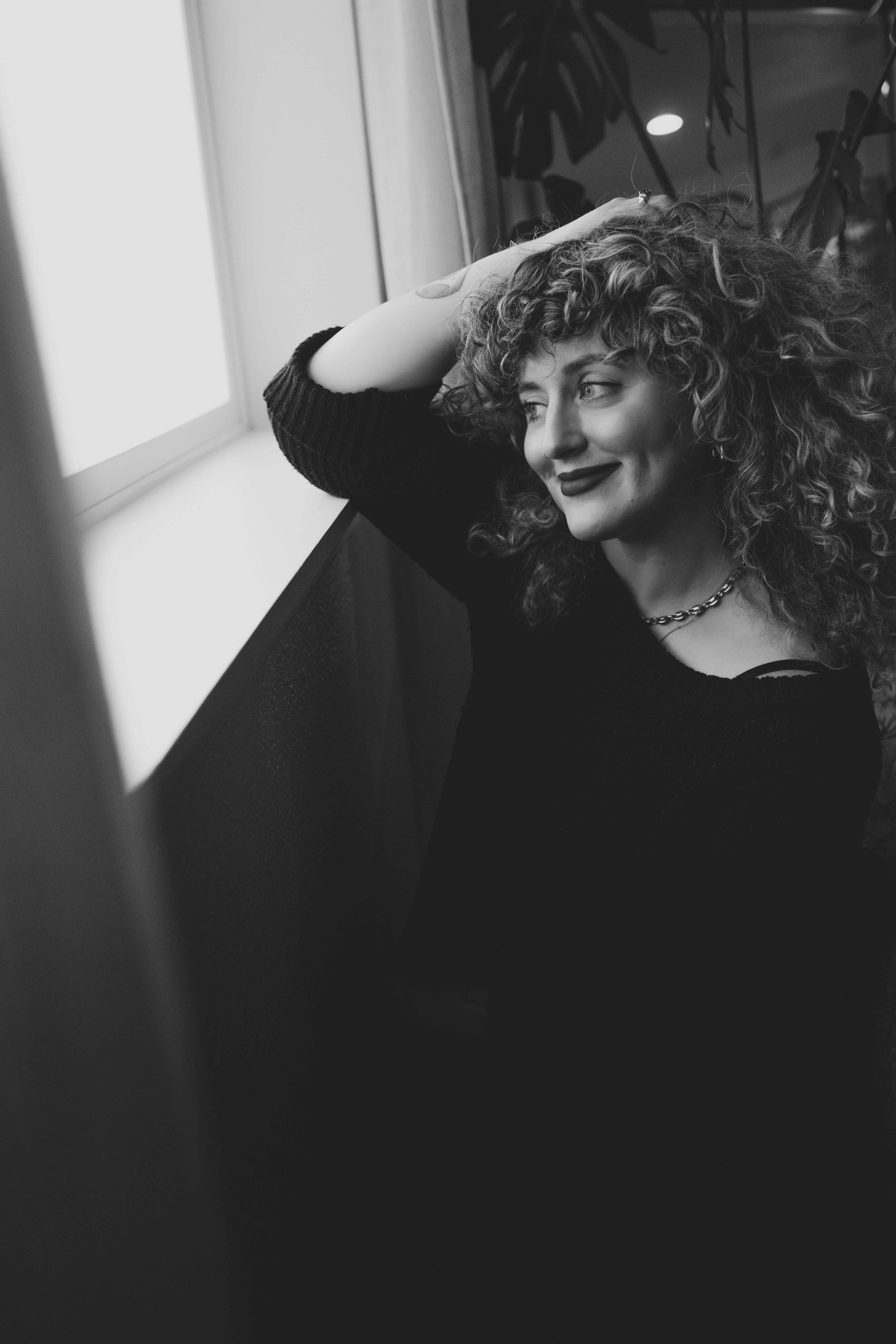 Bri from Pixel City Design smiling in a windowsill